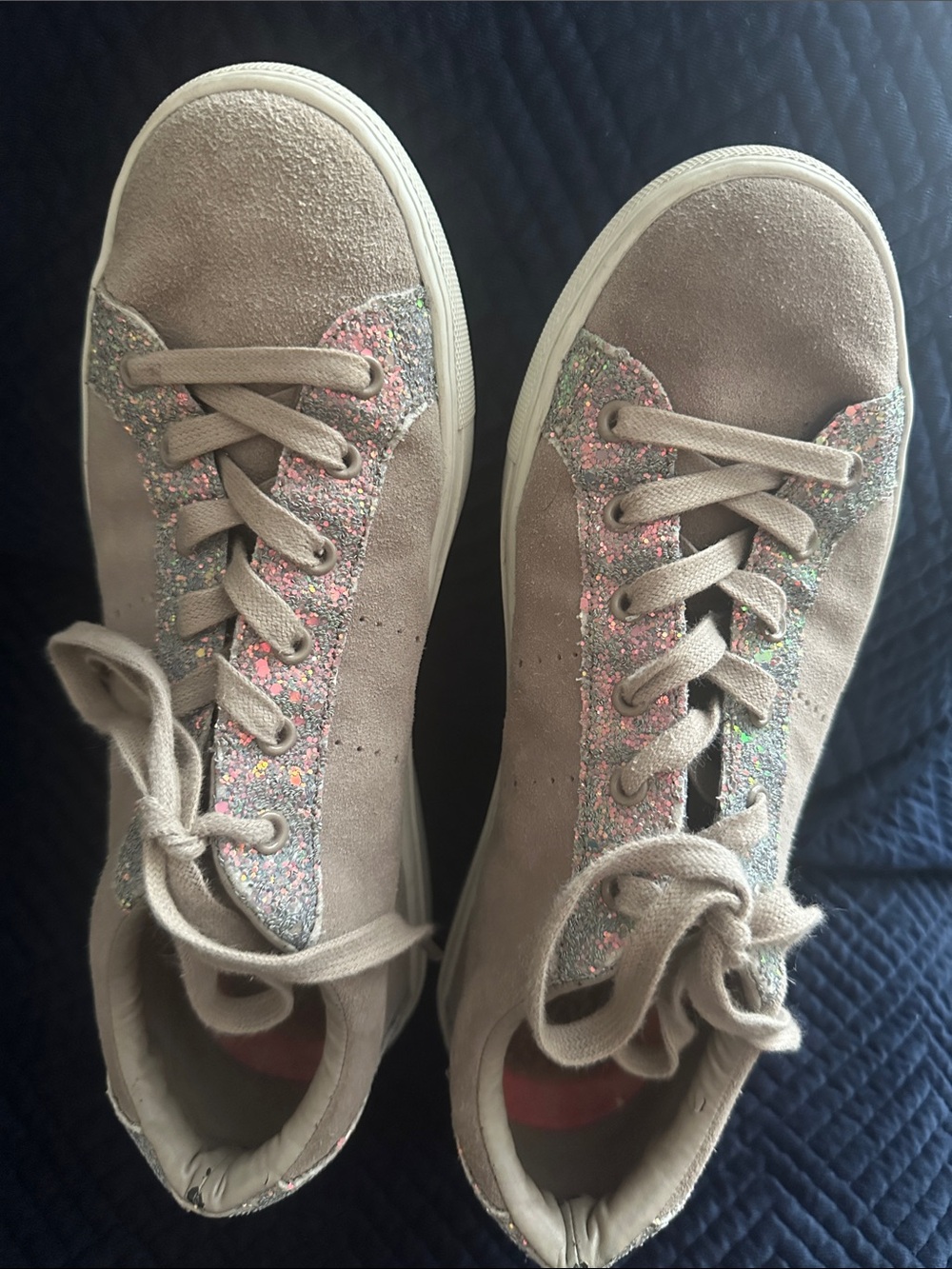 Skechers women’s beige suede sneakers with metallic trim.